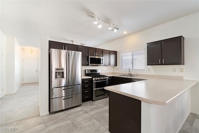 Kitchen with chocolate cabinetry, appliances with