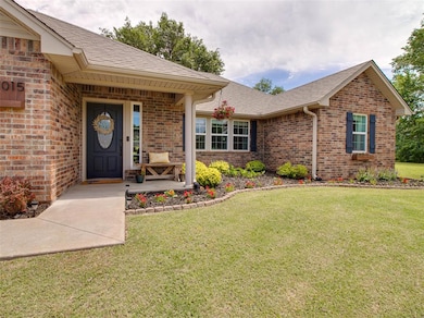 Property entrance featuring brick siding, a lawn, 