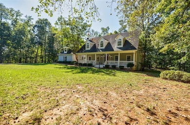 New england style home featuring a front yard and 