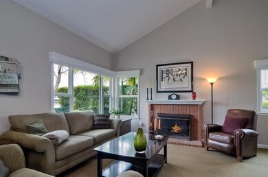 With vaulted ceiling and brick fireplace as the focal point