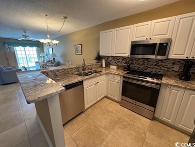 Kitchen with stainless steel appliances, a sink, a