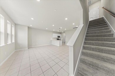 Stairway with tile patterned flooring, baseboards