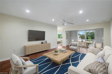 VIRTUALLY STAGED Living area with dark wood-style floors, plenty of natural light, recessed lighting, and a ceiling fan