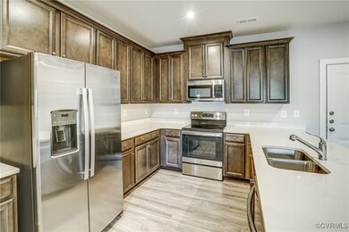 Kitchen featuring dark brown cabinetry, sink, ligh