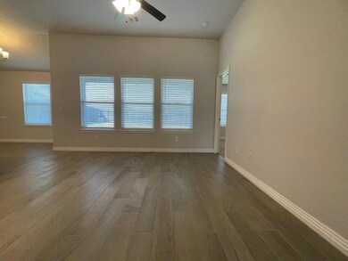 Spare room with wood finished floors and ceiling fan