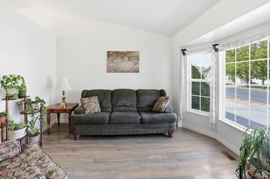 Living area featuring lofted ceiling and wood finished floors