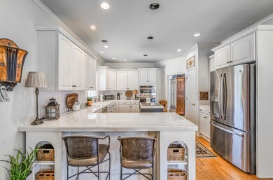 Kitchen featuring a breakfast bar, backsplash, lig