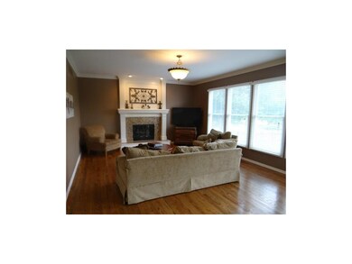 Open Great Room With Tile Fireplace, Crown Molding