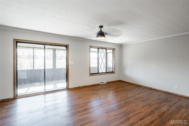 Unfurnished room with wood finished floors and ornamental molding