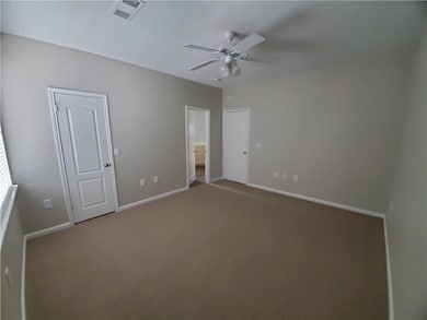 Unfurnished bedroom featuring carpet flooring, ba