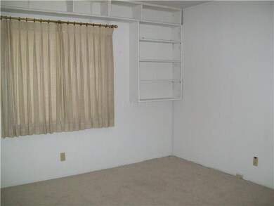 Another bedroom with shelving and nice closet.