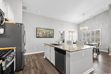 Kitchen with white cabinetry, sink, a kitchen isla