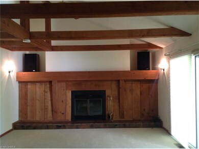 Family room with pitched ceiling and wood beams.  