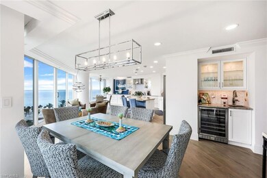 Dining space featuring ornamental molding, beverag