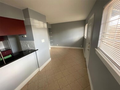 Kitchen featuring baseboards, dark countertops, d
