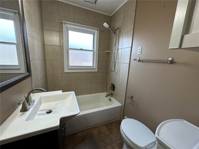 Updated 1st floor bathroom with tile tub surround,