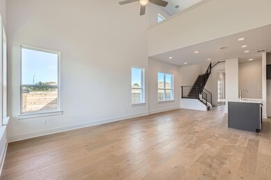 Unfurnished living room featuring stairway, light