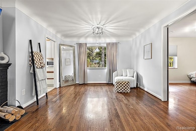 Unfurnished room featuring dark wood-style floors and plenty of natural light