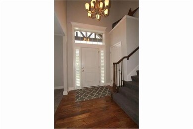 Defined 2 story entry with hardwood floors, double
