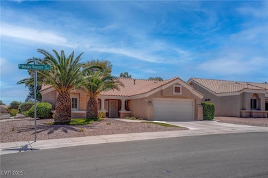View of front of property with a garage, stucco si