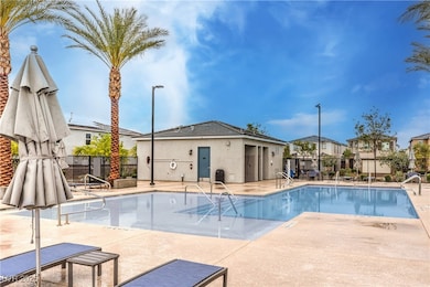 Community pool featuring a patio area and fence