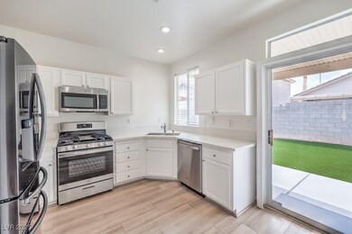 Kitchen featuring light wood-style floors, white c