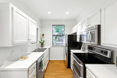 Kitchen featuring open shelves, white cabinetry, 