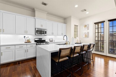 Your kitchen blends modern elegance with daily functionality—white shaker cabinets, gold hardware, and a stunning waterfall island that doubles as your favorite breakfast spot or evening wine bar. Every inch feels tailored for comfort and class.