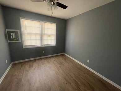 Empty room with hardwood / wood-style flooring and