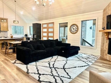 Living room with wooden walls, a notable chandelie