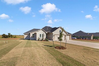 View of front of house with a garage and a front l