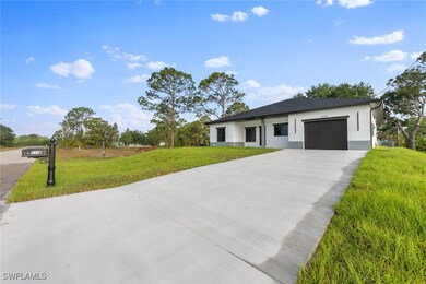 View of front of house with a garage, concrete dri