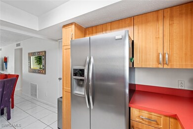 Kitchen with light tile patterned floors, stainles