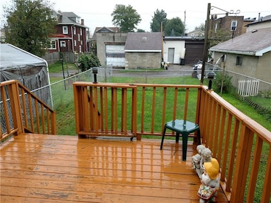 Deck off of the kitchen with fenced yard and off s