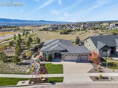 Property is situated on a corner lot backing to open space and views of Pikes Peak