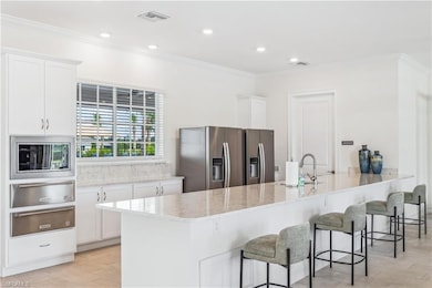 Kitchen featuring white cabinets, stainless steel 