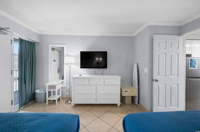 Tiled bedroom with stainless steel fridge and crow