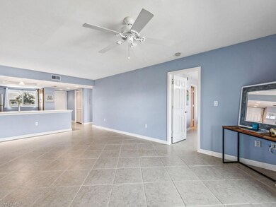 Unfurnished living room featuring light tile patte