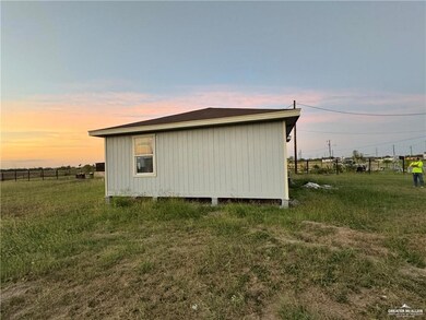 Property exterior at dusk with a lawn