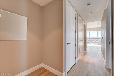 Hall with baseboards and light wood finished floor