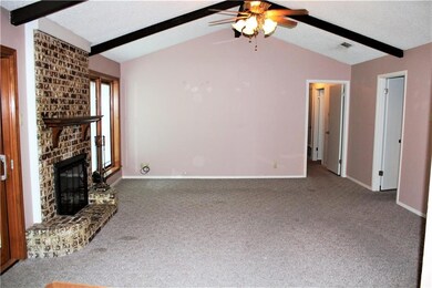 Another view of living area.  Paint that brick and