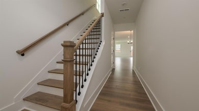 Stairs featuring wood finished floors and baseboards