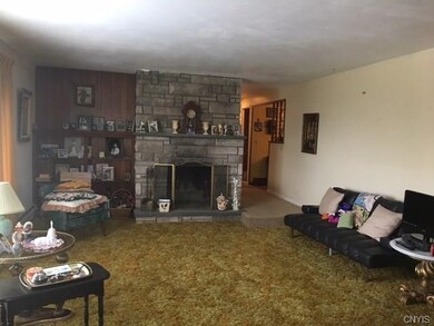 Living room with a wood burning fireplace