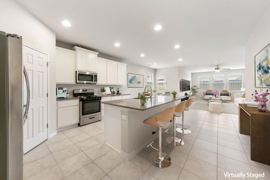 Kitchen with light tile patterned floors, a kitch