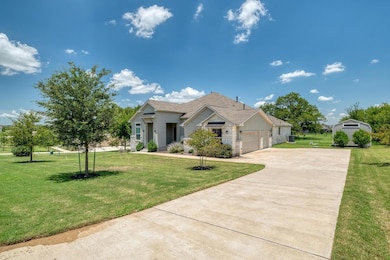 View of front facade featuring driveway, a garage