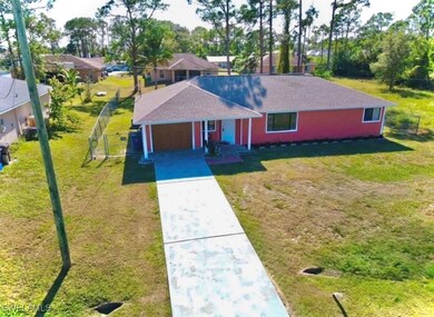 Ranch-style home featuring a front lawn and a gara