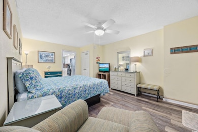 Bedroom with baseboards, a textured ceiling, frees