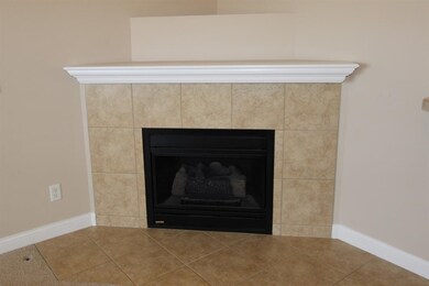 The corner, tiled fireplace is gas operated so the