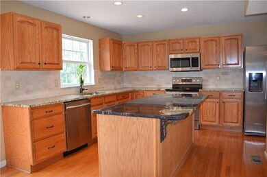 Center island kitchen has contrasting granite tops