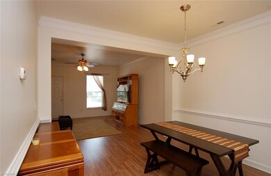 The dining room features a nice pendant fixture, chair rail and crown molding.
